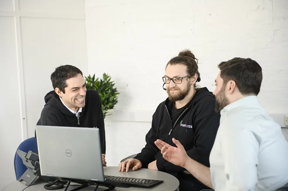 small business it support image of inventas support team around a laptop